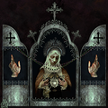 An open prayer box with hands on either side and a woman holding a silver heart in the middle
